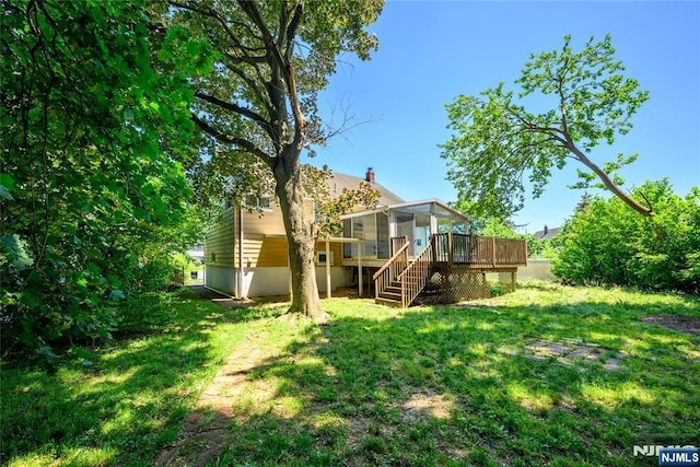 69 Lorraine Dr, Clifton, NJ 07012 - view of grassy yard featuring a sunroom, stairs, and a deck