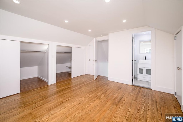 69 Lorraine Dr, Clifton, NJ 07012 - unfurnished bedroom featuring vaulted ceiling, two closets, light wood finished floors, recessed lighting, and ensuite bath