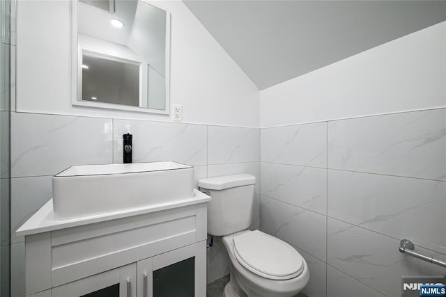 69 Lorraine Dr, Clifton, NJ 07012 - bathroom featuring tile walls, vanity, and lofted ceiling