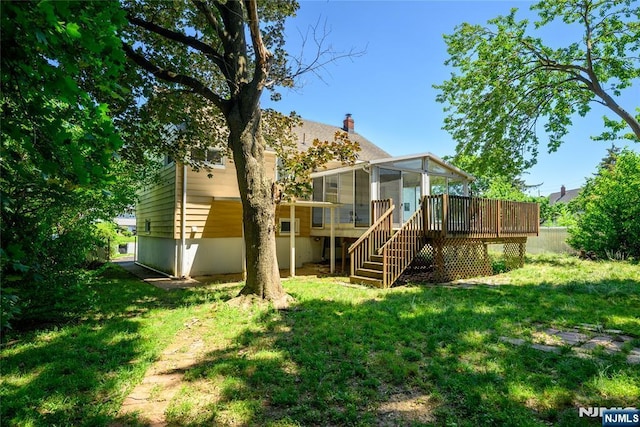 69 Lorraine Dr, Clifton, NJ 07012 - back of house featuring a sunroom, stairs, a deck, and a lawn
