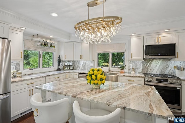 15 Barberry Way, Essex Fells, NJ 07021 - kitchen featuring appliances with stainless steel finishes, healthy amount of natural light, a center island, ornamental molding, and recessed lighting