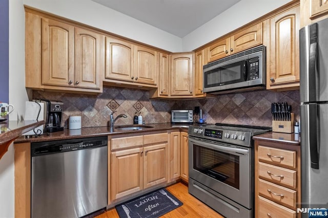 141 N Maple Ave Unit 141, Park Ridge, NJ 07656 - kitchen featuring appliances with stainless steel finishes, decorative backsplash, and light wood finished floors