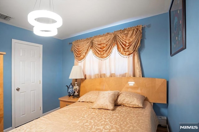 131 Shaler Ave, Fairview, NJ 07022 - bedroom featuring a chandelier and a baseboard radiator