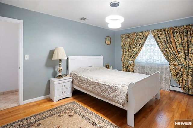 131 Shaler Ave, Fairview, NJ 07022 - bedroom with wood finished floors and baseboard heating