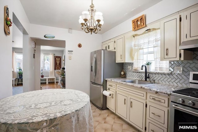 131 Shaler Ave, Fairview, NJ 07022 - kitchen with appliances with stainless steel finishes, a chandelier, backsplash, and hanging light fixtures