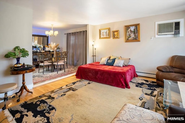 131 Shaler Ave, Fairview, NJ 07022 - living area with a chandelier, wood finished floors, a wall mounted AC, and baseboard heating