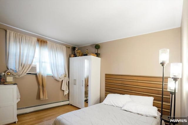 131 Shaler Ave, Fairview, NJ 07022 - bedroom featuring a baseboard radiator, wood finished floors, and cooling unit