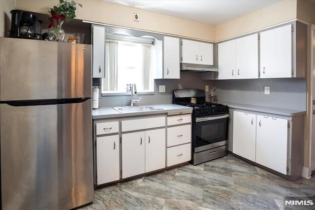 131 Shaler Ave, Fairview, NJ 07022 - kitchen featuring appliances with stainless steel finishes, under cabinet range hood, light countertops, and white cabinets