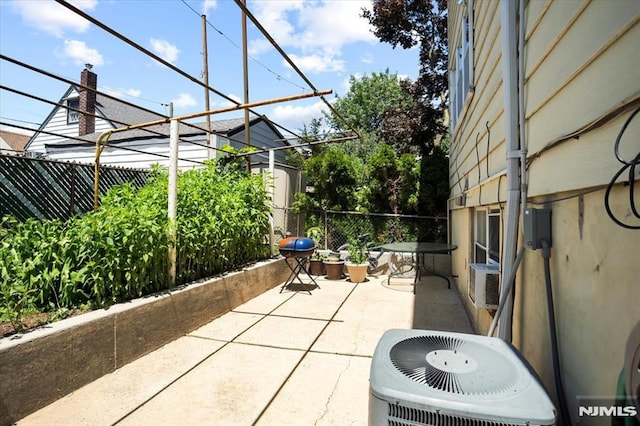 131 Shaler Ave, Fairview, NJ 07022 - fenced backyard with a patio, cooling unit, and area for grilling