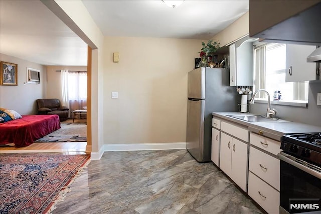 131 Shaler Ave, Fairview, NJ 07022 - kitchen featuring appliances with stainless steel finishes, white cabinetry, light marble finish floors, light countertops, and open floor plan