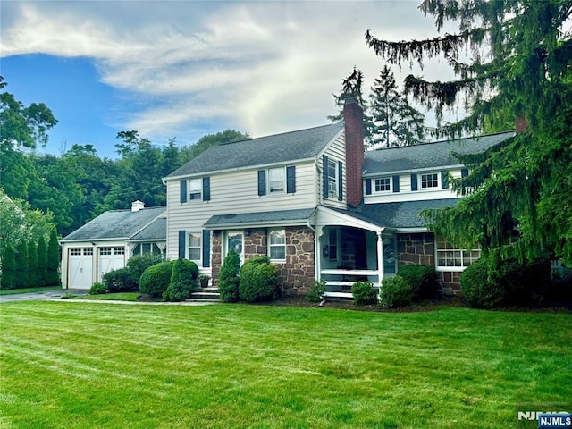 821 Glen Ave, Ridgewood, NJ 07450 - view of front of property featuring stone siding, driveway, a front yard, and a garage