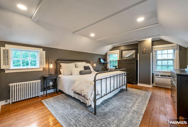 821 Glen Ave, Ridgewood, NJ 07450 - bedroom featuring radiator heating unit, hardwood / wood-style floors, vaulted ceiling, and multiple windows