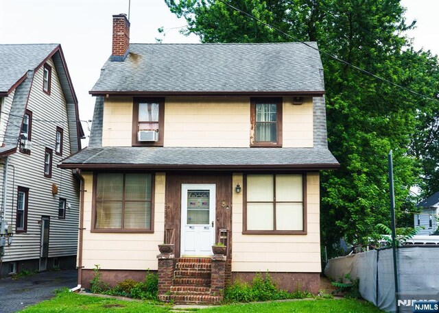 5 Grove St, Bloomfield, NJ 07003 - view of front of house featuring a chimney and roof with shingles