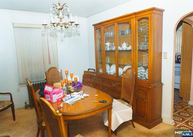 5 Grove St, Bloomfield, NJ 07003 - carpeted dining space with arched walkways and a chandelier