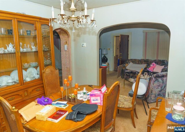 5 Grove St, Bloomfield, NJ 07003 - dining area featuring arched walkways, carpet flooring, crown molding, and a chandelier