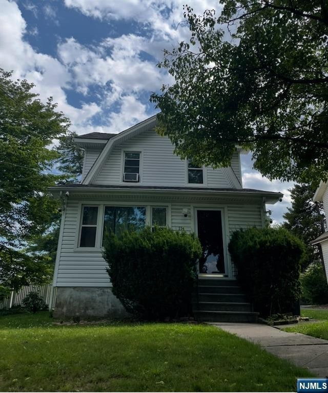 114 Hillside Ave, Teaneck, NJ 07666 - colonial inspired home featuring a front yard and a gambrel roof