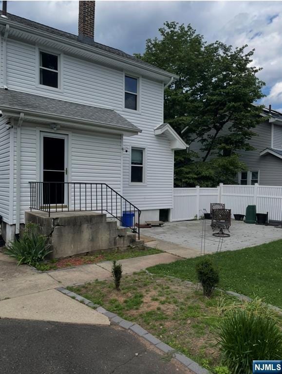 114 Hillside Ave, Teaneck, NJ 07666 - rear view of property with a patio area, a chimney, and a shingled roof