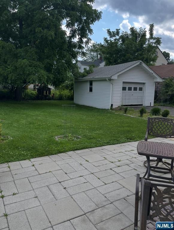 114 Hillside Ave, Teaneck, NJ 07666 - view of patio / terrace with a garage and an outbuilding