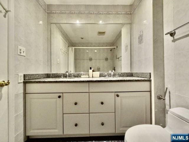 380 Whimbrel Ln Unit 380, Secaucus, NJ 07094 - bathroom with tile walls, double vanity, and a stall shower