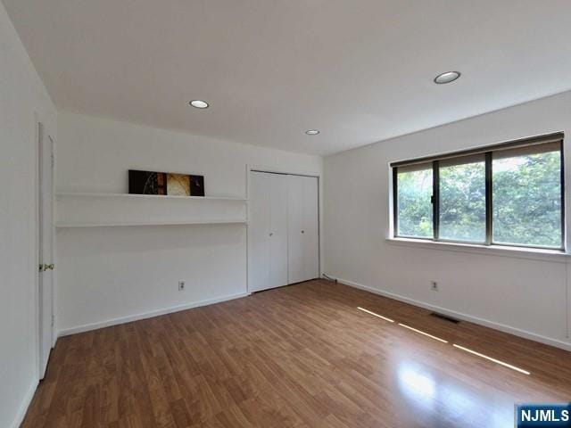 380 Whimbrel Ln Unit 380, Secaucus, NJ 07094 - unfurnished bedroom featuring wood finished floors, recessed lighting, and a closet