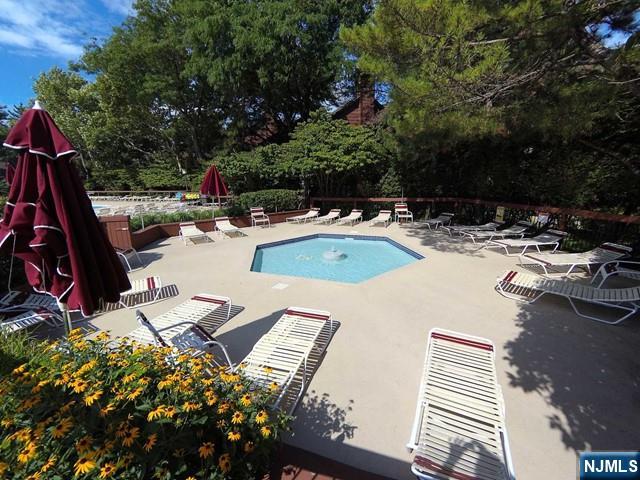 380 Whimbrel Ln Unit 380, Secaucus, NJ 07094 - community pool featuring a patio area and view of scattered trees