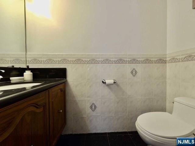 380 Whimbrel Ln Unit 380, Secaucus, NJ 07094 - bathroom with vanity, tile walls, tile patterned floors, and a wainscoted wall