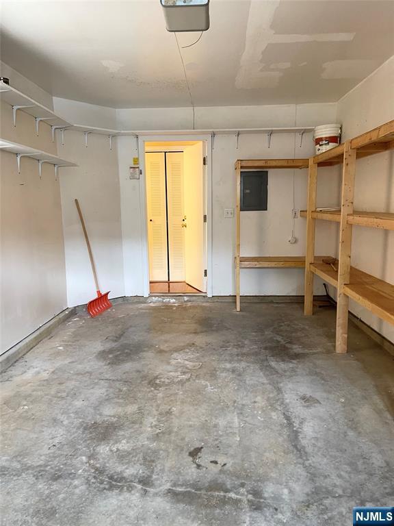 214 Manahan Rd Unit 214, East Brunswick, NJ 08816 - garage with electric panel and a garage door opener
