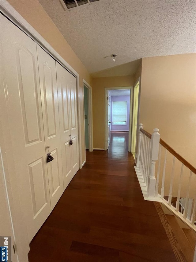 214 Manahan Rd Unit 214, East Brunswick, NJ 08816 - hallway with wood finished floors, a textured ceiling, and an upstairs landing