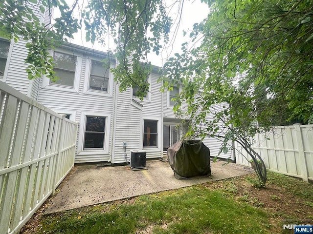 214 Manahan Rd Unit 214, East Brunswick, NJ 08816 - rear view of house featuring a fenced backyard and a patio area