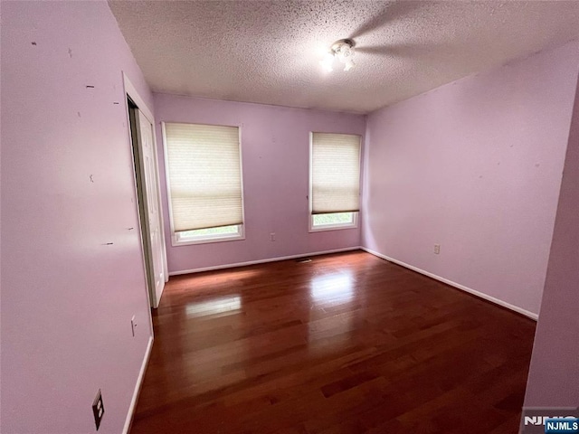 214 Manahan Rd Unit 214, East Brunswick, NJ 08816 - unfurnished room with wood finished floors and a textured ceiling