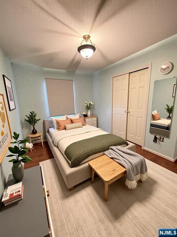 214 Manahan Rd Unit 214, East Brunswick, NJ 08816 - bedroom with wood finished floors, a closet, and a textured ceiling