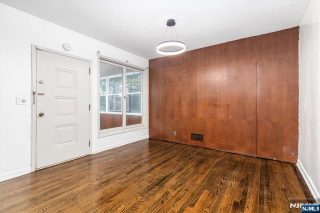 243 Lafayette Ave, Passaic, NJ 07055 - unfurnished dining area with wood finished floors and baseboards
