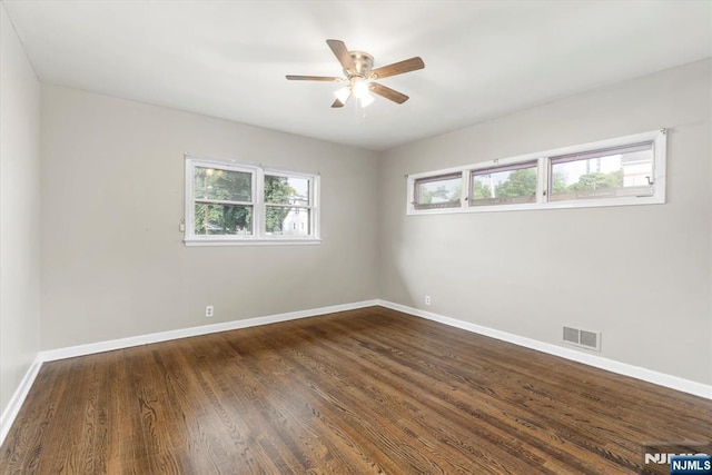 243 Lafayette Ave, Passaic, NJ 07055 - unfurnished room with healthy amount of natural light, a ceiling fan, and dark wood-type flooring