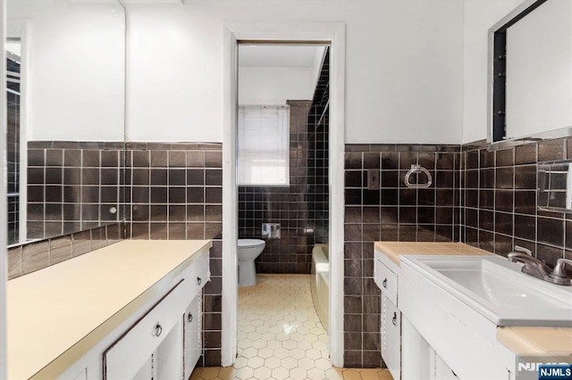 243 Lafayette Ave, Passaic, NJ 07055 - full bathroom with tile walls, vanity, tile patterned flooring, and wainscoting