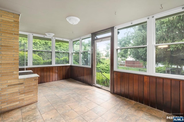 243 Lafayette Ave, Passaic, NJ 07055 - unfurnished sunroom featuring wooden walls and healthy amount of natural light