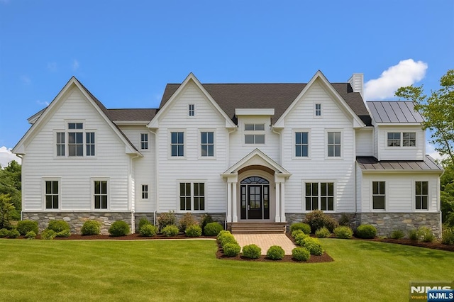 520 Clinton Ave, Wyckoff, NJ 07481 - view of front facade with a front yard, a standing seam roof, stone siding, and a metal roof