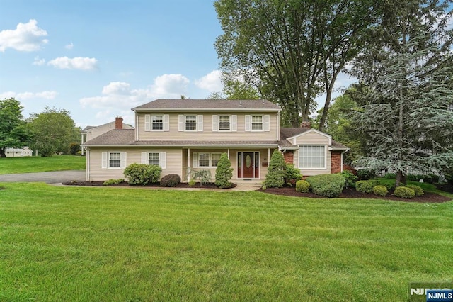 30 Sinclair Dr, Wayne, NJ 07470 - view of front of house featuring a front yard, a chimney, and covered porch