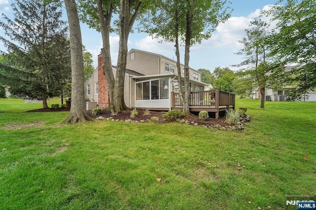 30 Sinclair Dr, Wayne, NJ 07470 - rear view of house featuring a sunroom, a wooden deck, a chimney, and a yard
