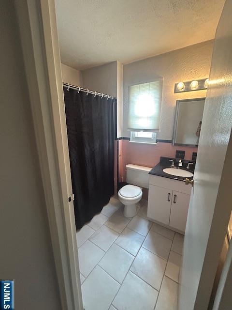 63 Roseland Ave Unit 54, Caldwell, NJ 07006 - full bathroom featuring vanity, a textured ceiling, and a shower with shower curtain