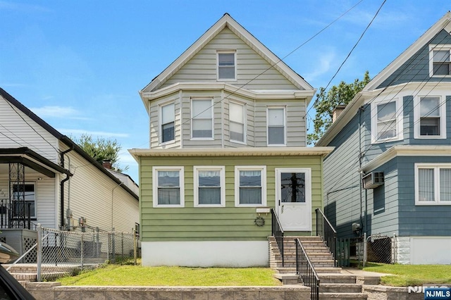 407 Elm St, Kearny, NJ 07032 - view of front of house featuring entry steps and a wall unit AC