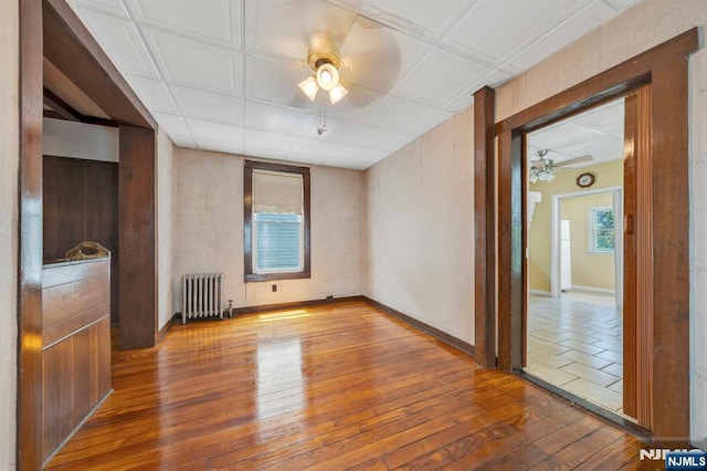 407 Elm St, Kearny, NJ 07032 - spare room featuring ceiling fan, radiator heating unit, hardwood / wood-style floors, and an ornate ceiling