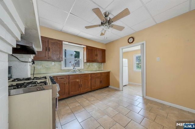 407 Elm St, Kearny, NJ 07032 - kitchen featuring range with gas stovetop, freestanding refrigerator, decorative backsplash, a ceiling fan, and a drop ceiling