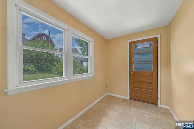 407 Elm St, Kearny, NJ 07032 - doorway to outside featuring baseboards and light stone finish floors