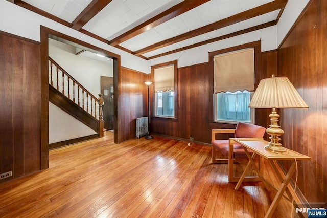 407 Elm St, Kearny, NJ 07032 - sitting room with radiator, beam ceiling, wood-type flooring, wood walls, and stairs