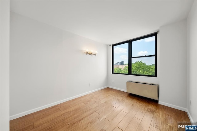 9019 Wall St Unit 6B, North Bergen, NJ 07047 - spare room with radiator and light wood-type flooring