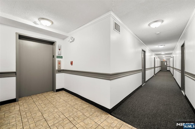 9019 Wall St Unit 6B, North Bergen, NJ 07047 - hallway with elevator, a textured ceiling, crown molding, and brick patterned floors