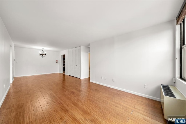 9019 Wall St Unit 6B, North Bergen, NJ 07047 - unfurnished room with a chandelier and light wood-type flooring