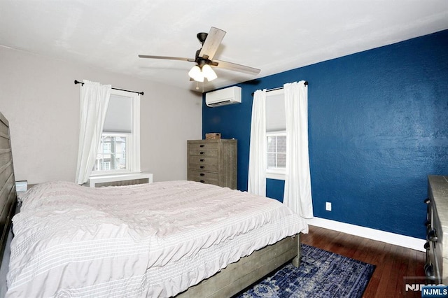 393 High St, Nutley, NJ 07110 - bedroom with a wall unit AC, wood finished floors, and a ceiling fan