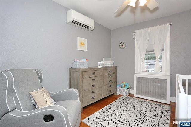 393 High St, Nutley, NJ 07110 - sitting room with a wall unit AC, ceiling fan, wood finished floors, and radiator heating unit