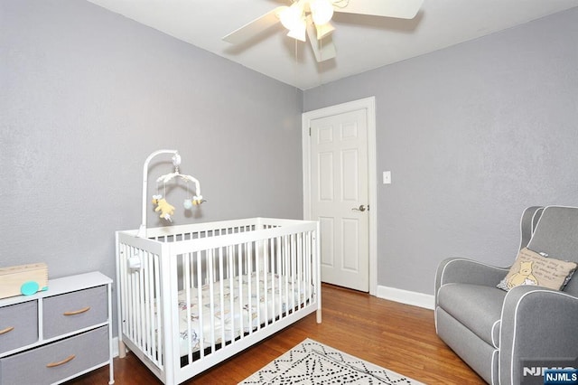 393 High St, Nutley, NJ 07110 - bedroom featuring wood finished floors, a nursery area, and ceiling fan